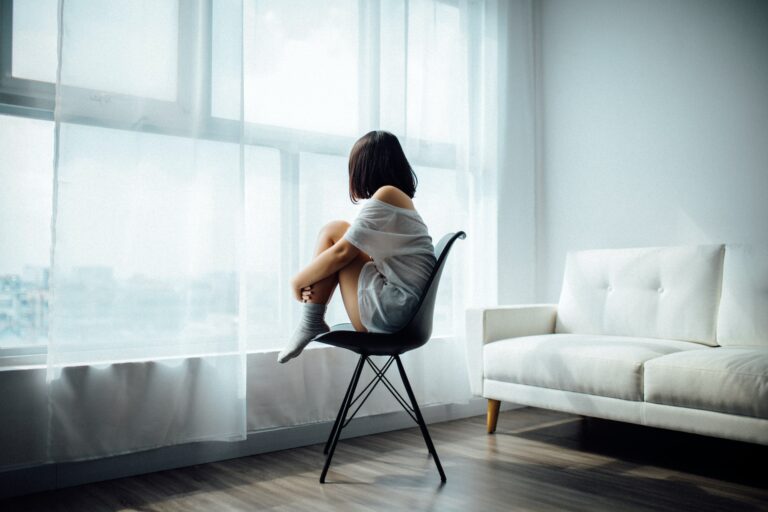 woman sitting near window