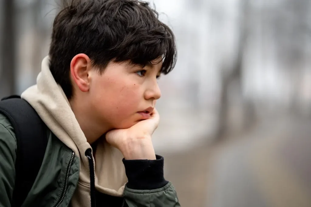 Young boy suffering from grief and needing treatment.